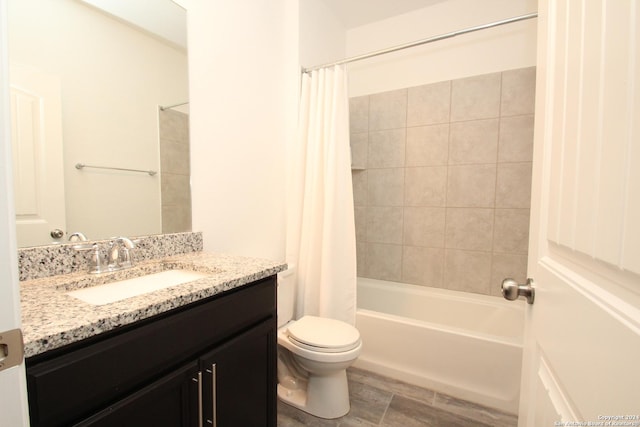 full bathroom with shower / tub combo, vanity, and toilet