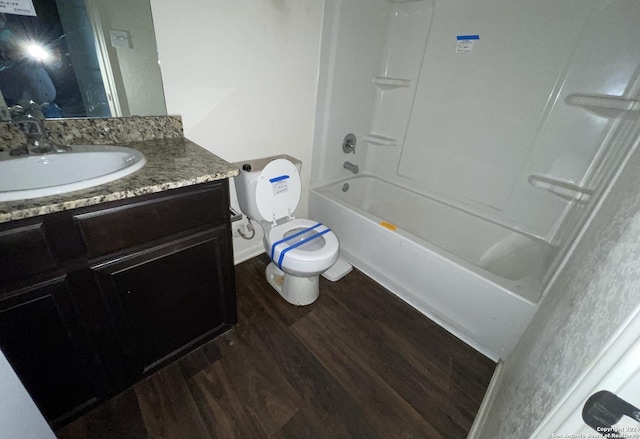 full bathroom with vanity, hardwood / wood-style flooring, toilet, and shower / washtub combination