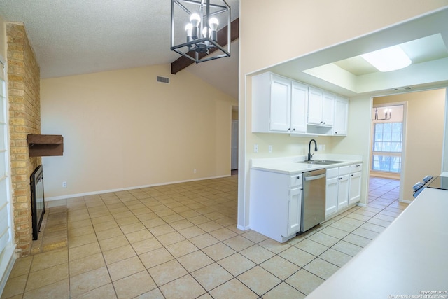 kitchen featuring stainless steel dishwasher, sink, pendant lighting, white cabinets, and light tile patterned flooring