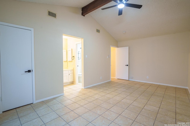 unfurnished bedroom with light tile patterned flooring, high vaulted ceiling, ensuite bathroom, ceiling fan, and beam ceiling