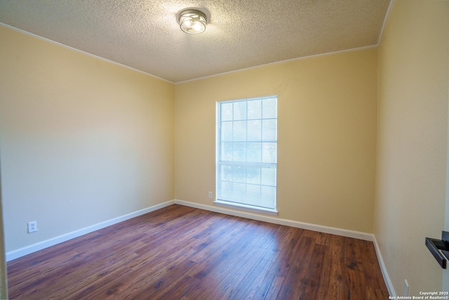 unfurnished room featuring a textured ceiling, crown molding, and dark wood-type flooring