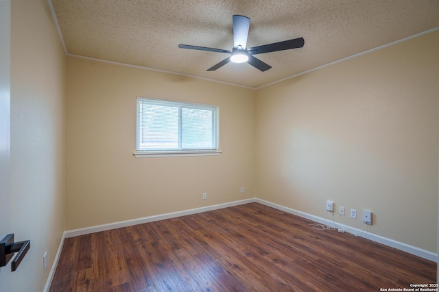 empty room with a textured ceiling, dark hardwood / wood-style floors, ceiling fan, and ornamental molding