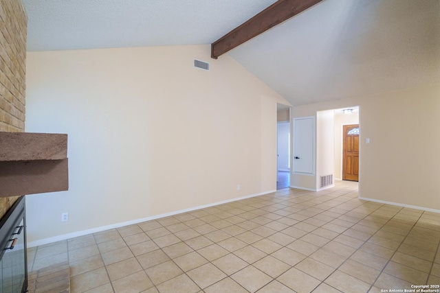 unfurnished living room with a textured ceiling, lofted ceiling with beams, and light tile patterned flooring