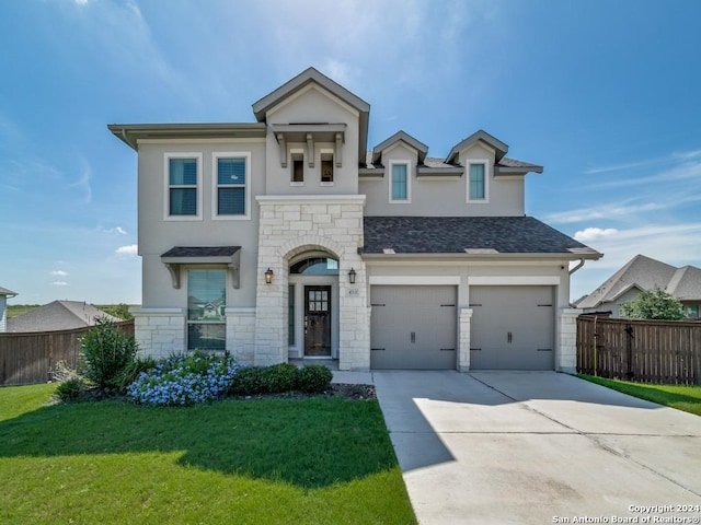 view of front of property with a front yard and a garage