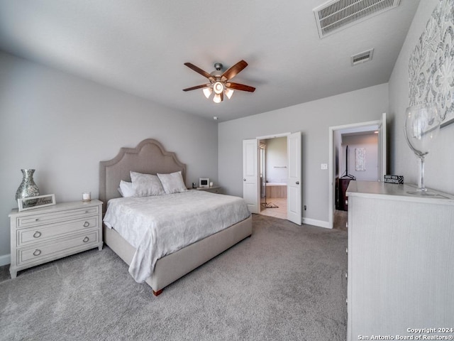 carpeted bedroom with connected bathroom and ceiling fan