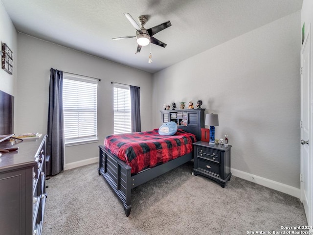 bedroom with ceiling fan and light carpet