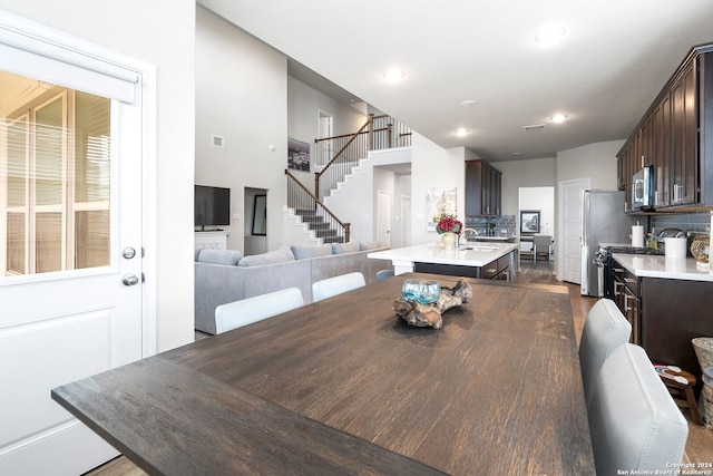 dining space featuring dark wood-type flooring and sink