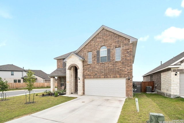 view of front of house featuring central AC, a garage, and a front lawn