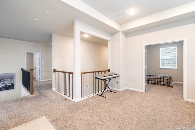 corridor with light colored carpet