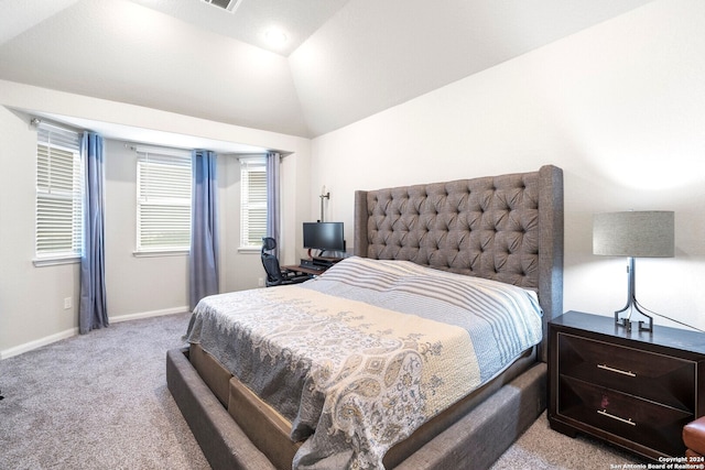 bedroom featuring light carpet and vaulted ceiling