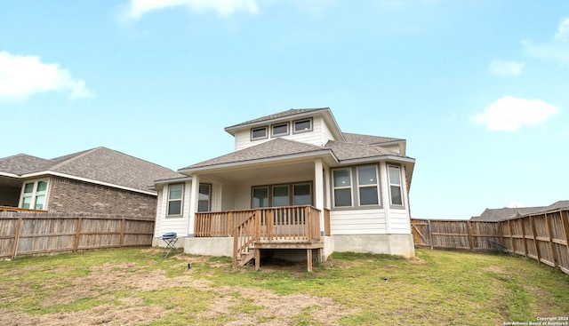 rear view of property featuring a lawn