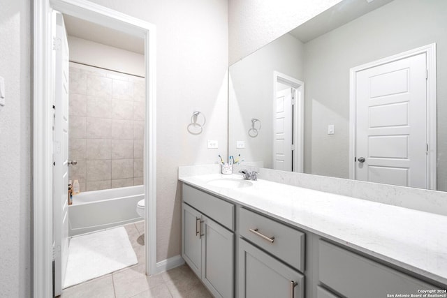 full bathroom featuring toilet, vanity, tiled shower / bath combo, and tile patterned floors