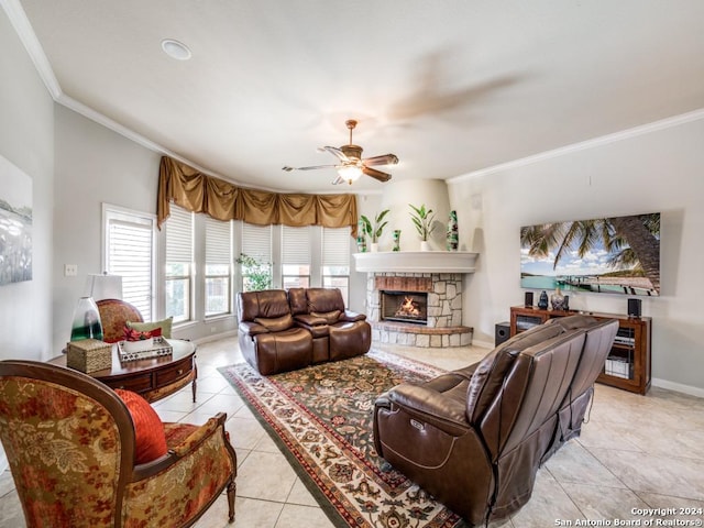 tiled living room with a fireplace, ceiling fan, and ornamental molding