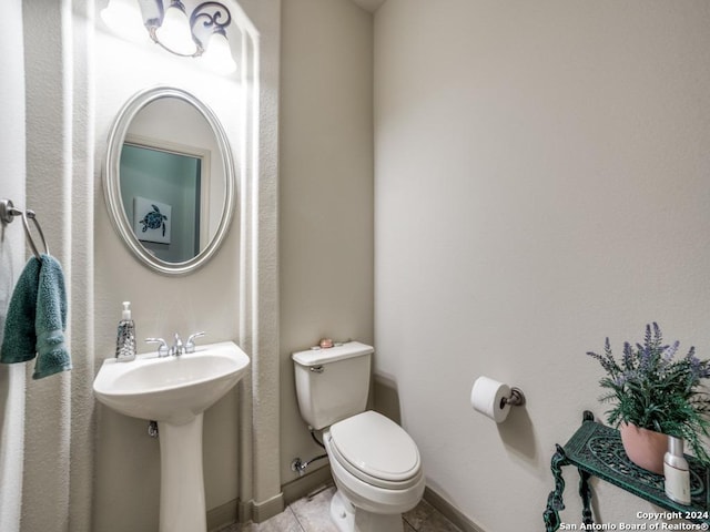 bathroom with tile patterned floors, sink, and toilet