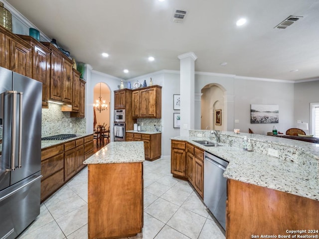 kitchen featuring decorative backsplash, sink, a spacious island, and appliances with stainless steel finishes