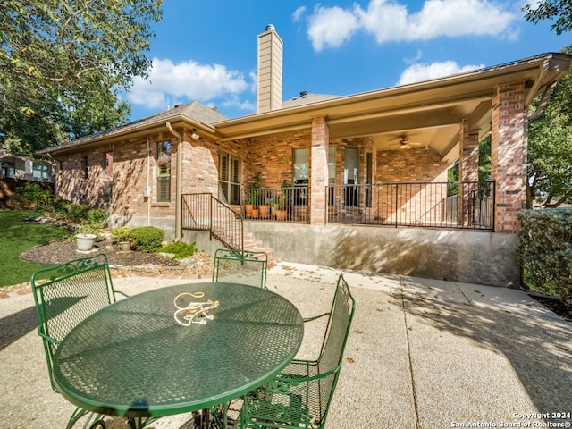 back of property featuring ceiling fan and a patio area