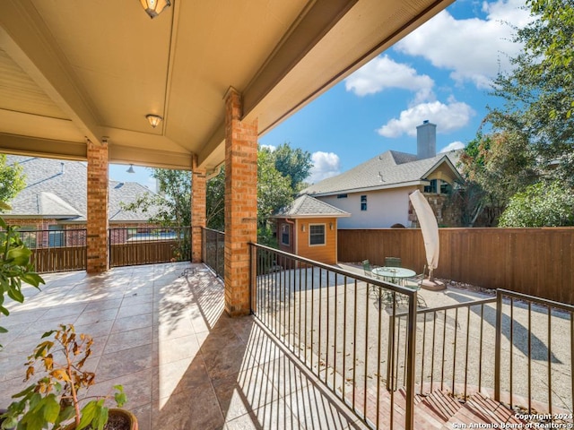 view of patio / terrace featuring a storage unit