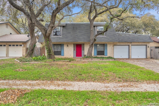 view of front of house featuring a garage and a front lawn