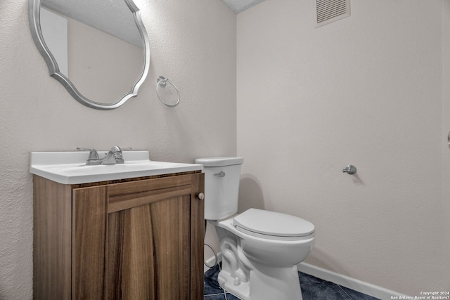 bathroom with tile patterned floors, vanity, and toilet