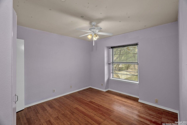 unfurnished room with ceiling fan and hardwood / wood-style flooring