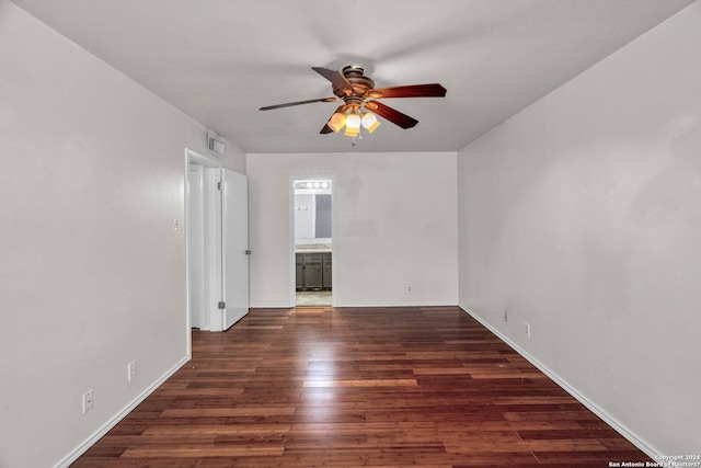 spare room featuring ceiling fan and dark hardwood / wood-style flooring