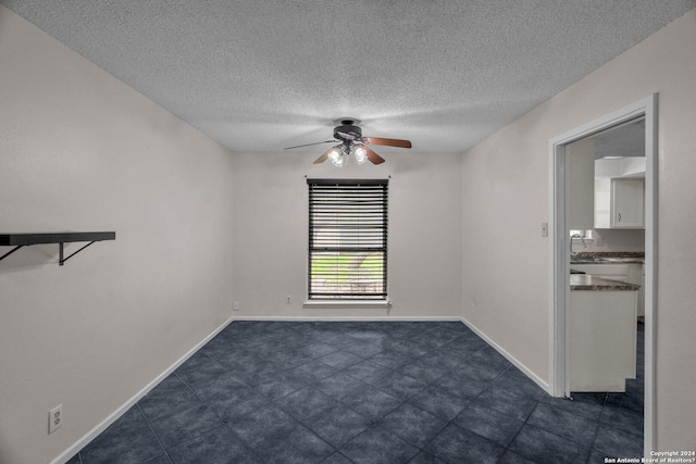 empty room featuring a textured ceiling, ceiling fan, and sink