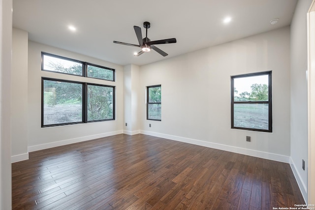 unfurnished room with dark hardwood / wood-style flooring and ceiling fan