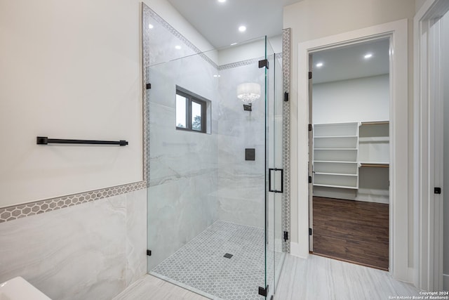 bathroom featuring a shower with door