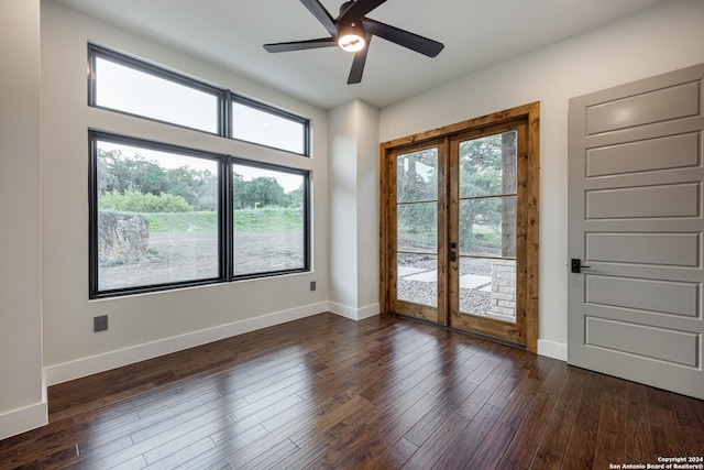 unfurnished room with ceiling fan, dark wood-type flooring, and french doors