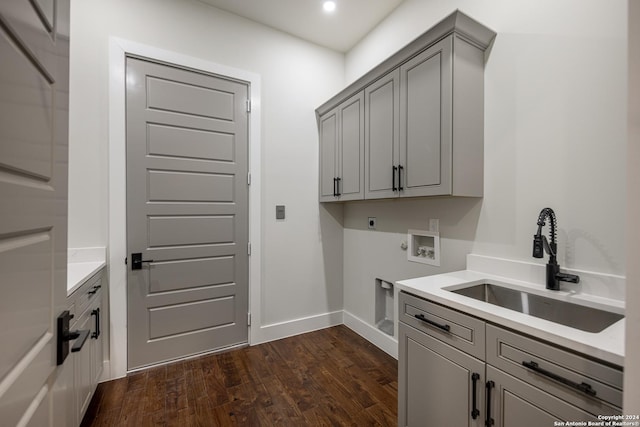 laundry area featuring cabinets, dark wood-type flooring, sink, washer hookup, and hookup for an electric dryer