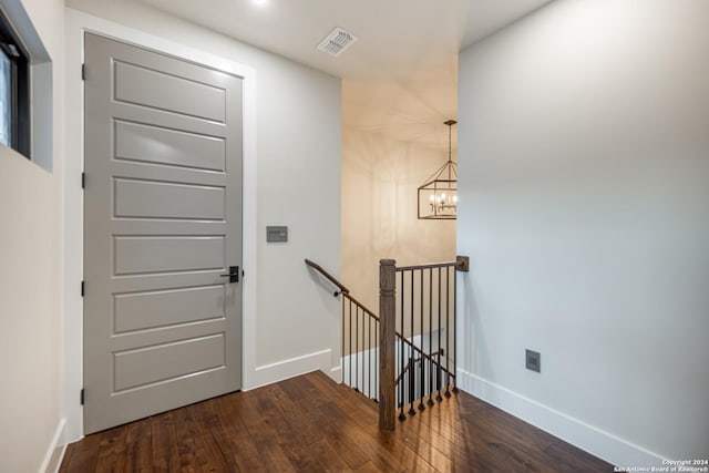 entryway featuring a notable chandelier and dark wood-type flooring