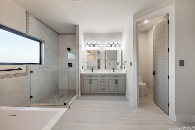 full bathroom featuring tile patterned flooring, vanity, toilet, and independent shower and bath