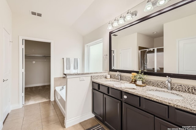 bathroom featuring tile patterned floors, vanity, and shower with separate bathtub