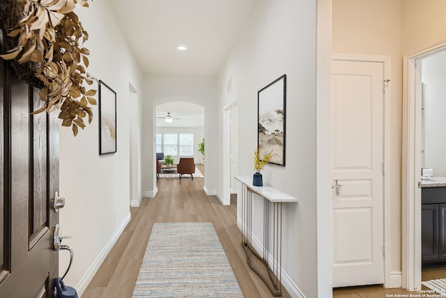 corridor with light hardwood / wood-style floors