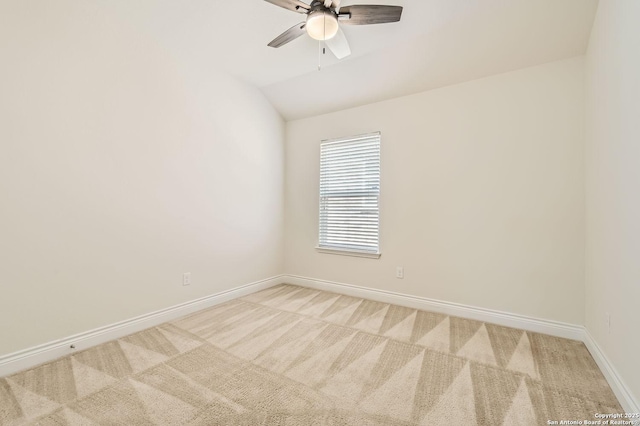 carpeted empty room featuring ceiling fan and lofted ceiling