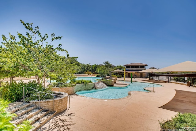 view of swimming pool with a gazebo, pool water feature, and a patio area