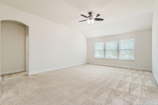 carpeted spare room featuring ceiling fan and lofted ceiling