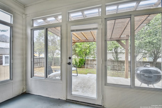 doorway to outside with concrete floors and a healthy amount of sunlight