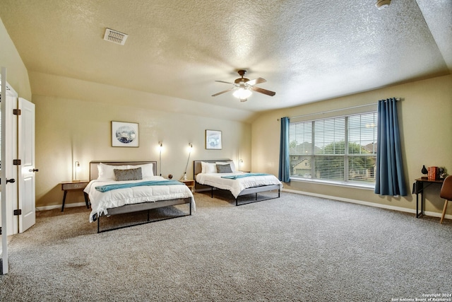 carpeted bedroom featuring ceiling fan, lofted ceiling, and a textured ceiling