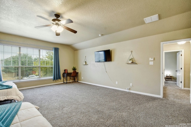 carpeted living room with a textured ceiling, ceiling fan, and lofted ceiling