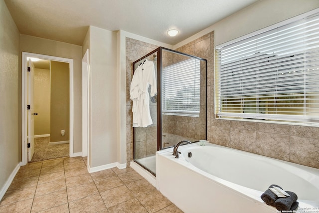 bathroom featuring separate shower and tub and tile patterned flooring