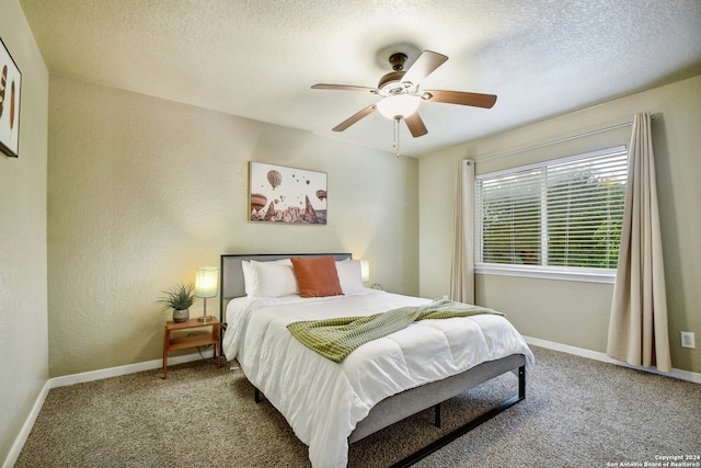 carpeted bedroom featuring a textured ceiling and ceiling fan