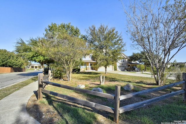 obstructed view of property with a front yard