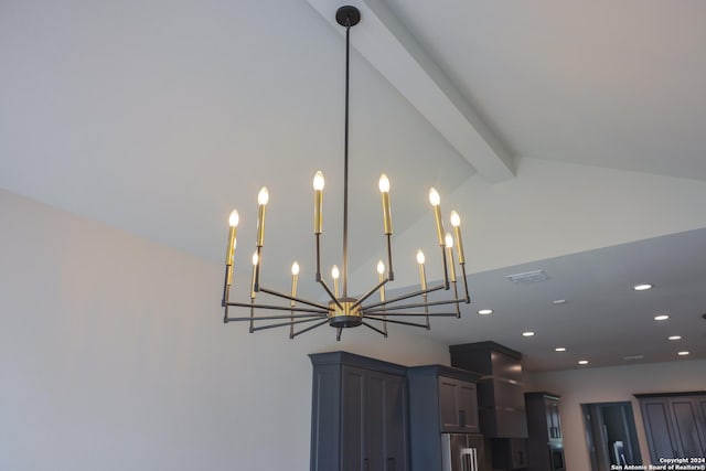 details featuring beam ceiling, an inviting chandelier, and high quality fridge