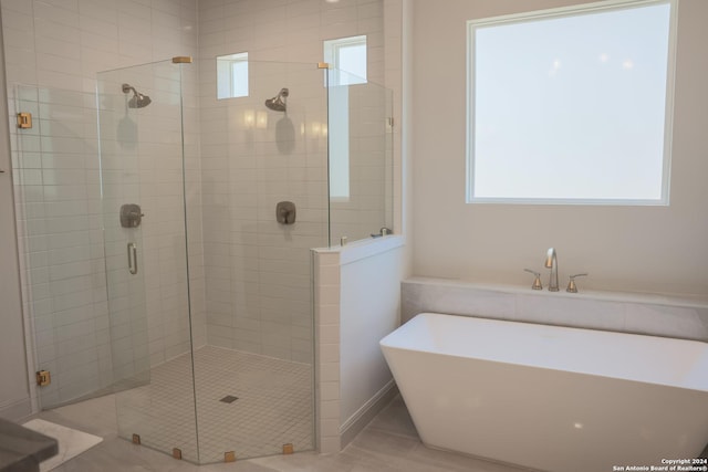 bathroom with separate shower and tub