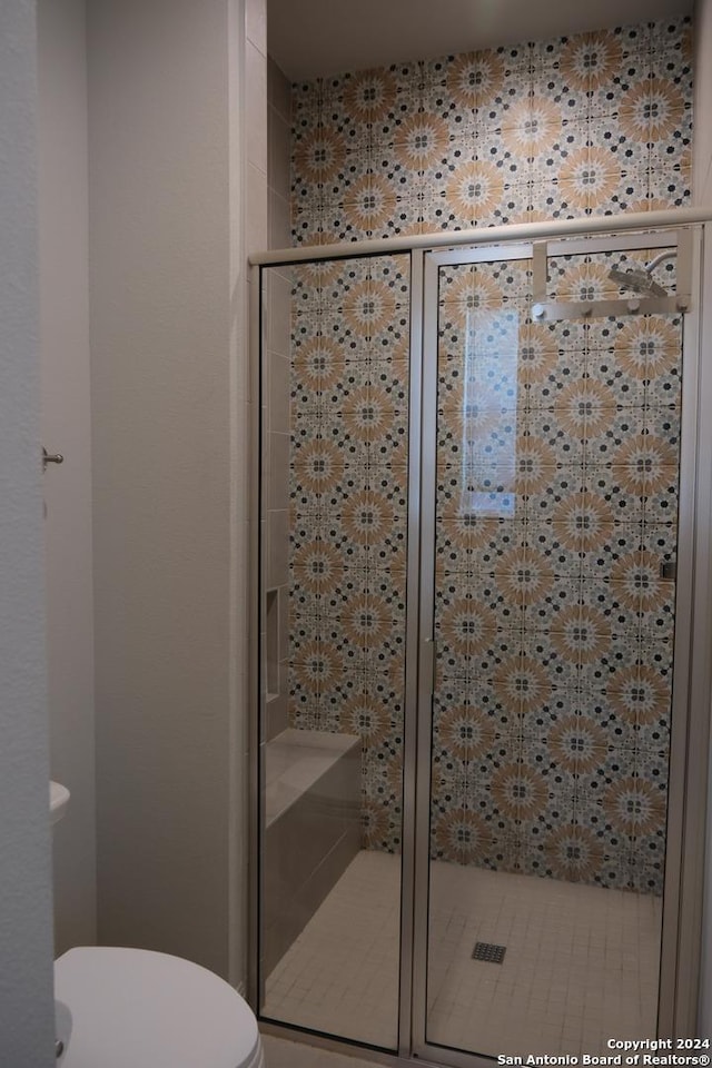 bathroom featuring toilet and walk in shower