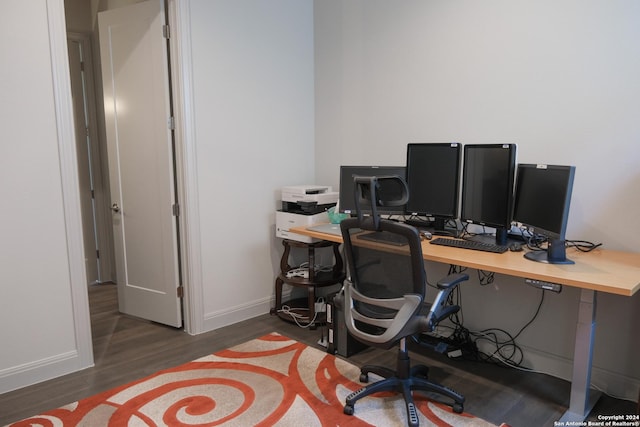 home office with dark wood-type flooring