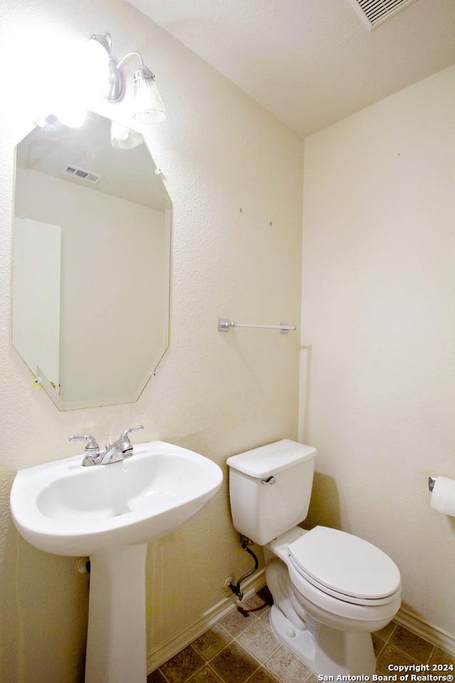 bathroom with tile patterned floors and toilet