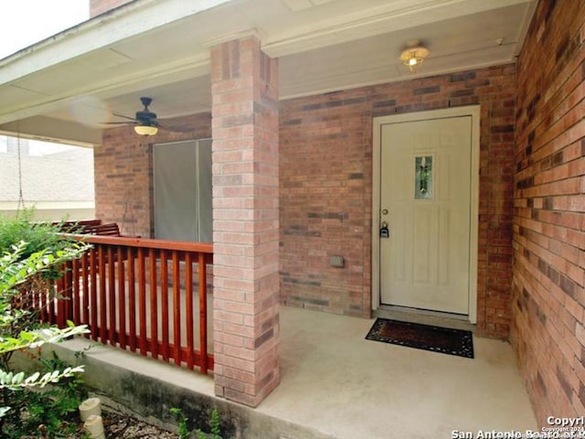 entrance to property with ceiling fan and covered porch