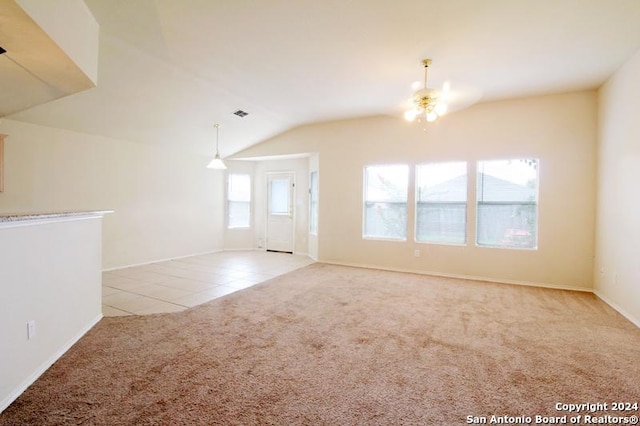 unfurnished living room with ceiling fan, light colored carpet, and vaulted ceiling